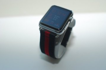 Apple Watch with silver accents with a black and red striped band